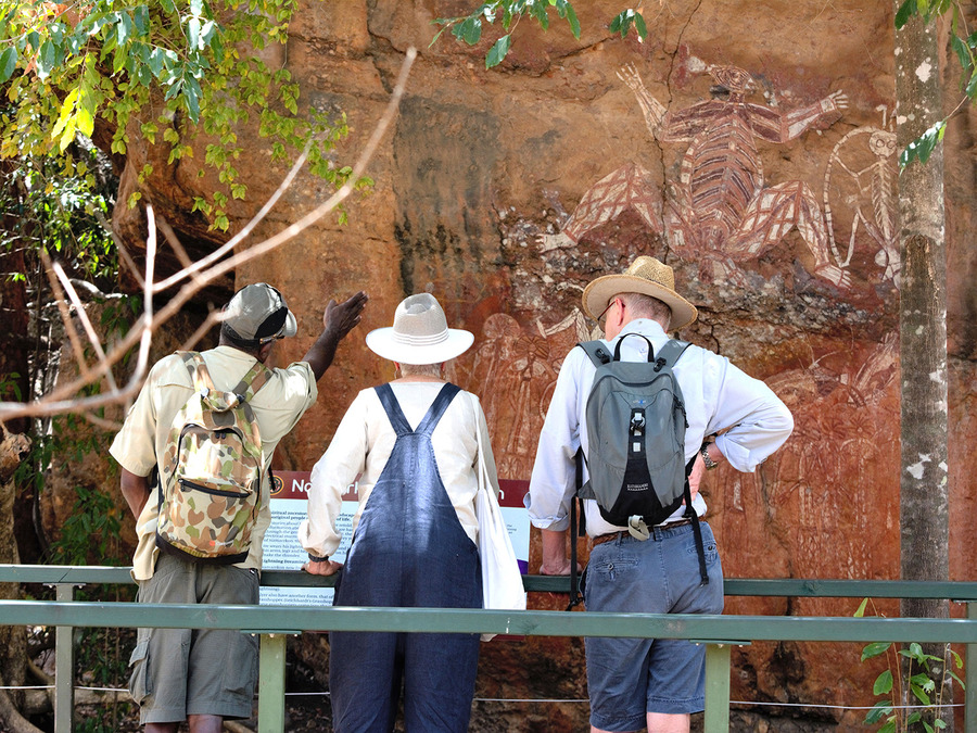 People looking at aboriginal rock art in Kakadu