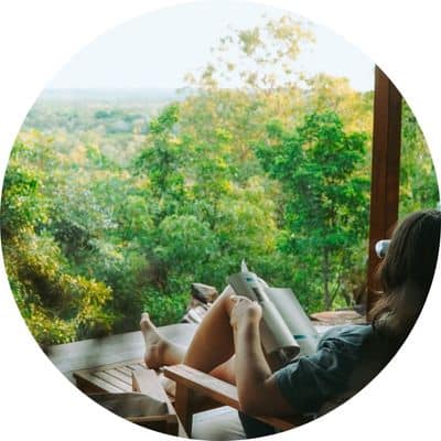 Woman reading a book on the deck at Ridge Retreat near Litchfield